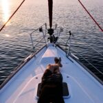 man lying on white boat